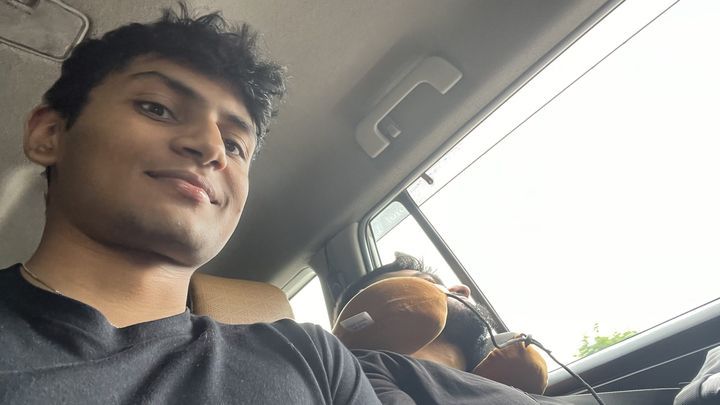 A smiling selfie from the front seat of a car