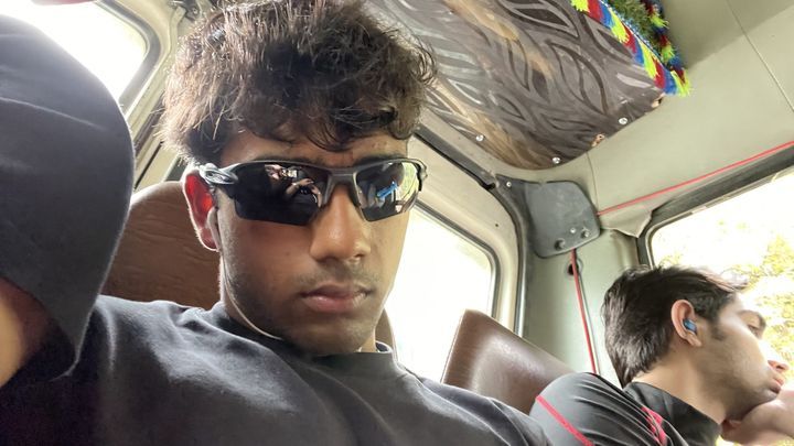 A friend in sunglasses inside a bus