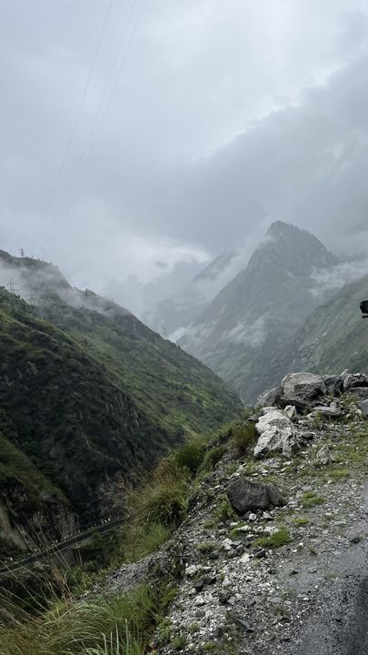 Cloud drifting through a steep green valley